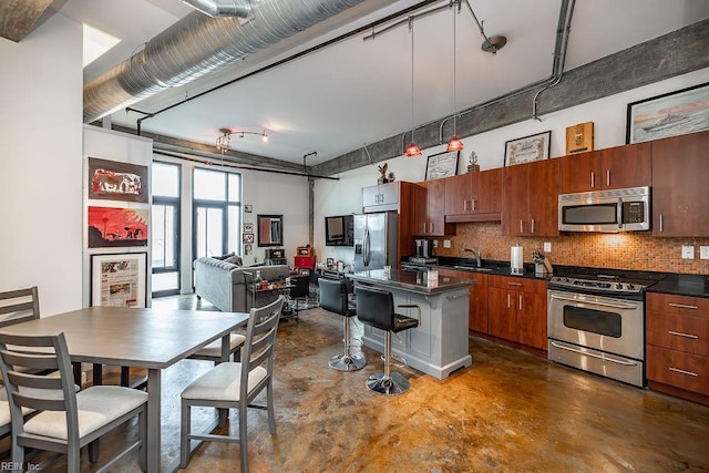 415 Saint Pauls Blvd Unit 309, Norfolk, VA 23510 - kitchen with stainless steel appliances, finished concrete flooring, dark countertops, and backsplash