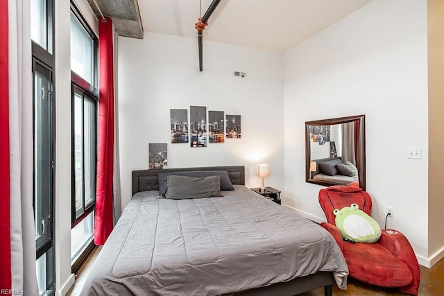 415 Saint Pauls Blvd Unit 309, Norfolk, VA 23510 - bedroom featuring multiple windows, baseboards, and a high ceiling