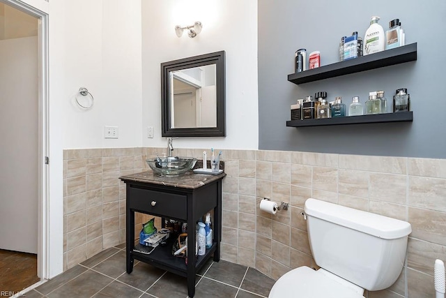 415 Saint Pauls Blvd Unit 309, Norfolk, VA 23510 - bathroom featuring tile walls, toilet, vanity, a wainscoted wall, and tile patterned flooring