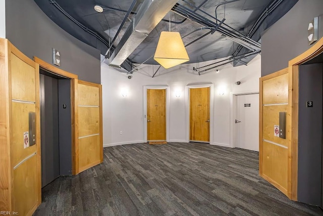 415 Saint Pauls Blvd Unit 309, Norfolk, VA 23510 - unfurnished living room featuring elevator, baseboards, a towering ceiling, and wood finished floors