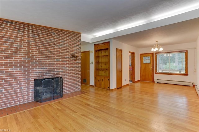 449 Martha Lee Dr, Hampton, VA 23666 - unfurnished living room with baseboard heating, wood finished floors, a chandelier, a brick fireplace, and baseboards