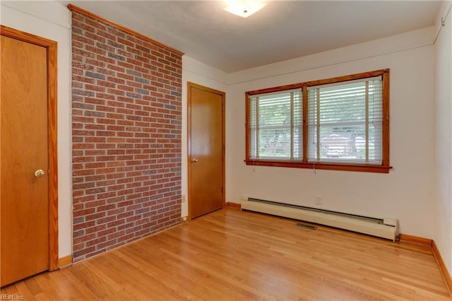 449 Martha Lee Dr, Hampton, VA 23666 - unfurnished room featuring a baseboard heating unit, light wood-style flooring, brick wall, and baseboards