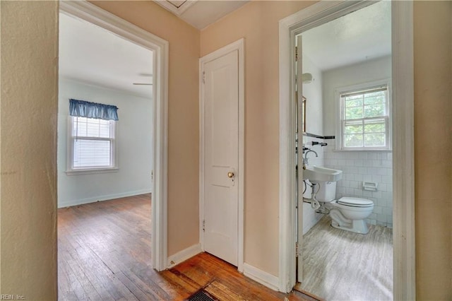 10 Dotson Dr, Hampton, VA 23669 - corridor featuring wood-type flooring, a sink, and tile walls