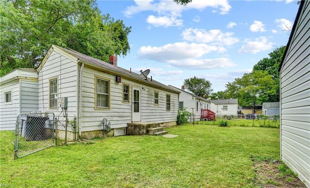 10 Dotson Dr, Hampton, VA 23669 - rear view of house with a chimney and cooling unit