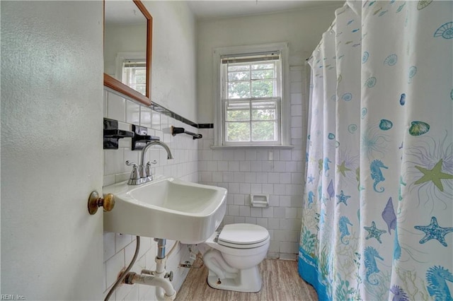 10 Dotson Dr, Hampton, VA 23669 - full bath with tile walls, toilet, a sink, wood finished floors, and a shower with shower curtain