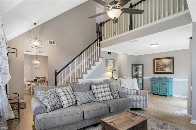 189 Shoal Crk, Williamsburg, VA 23185 - living room with high vaulted ceiling, wood finished floors, a chandelier, ceiling fan, and stairway