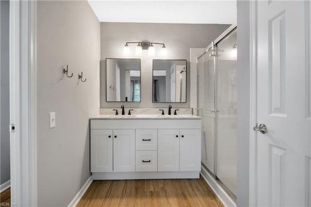 189 Shoal Crk, Williamsburg, VA 23185 - full bathroom featuring wood finished floors, double vanity, and a shower stall