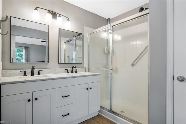 189 Shoal Crk, Williamsburg, VA 23185 - bathroom with a shower stall, double vanity, and wood finished floors