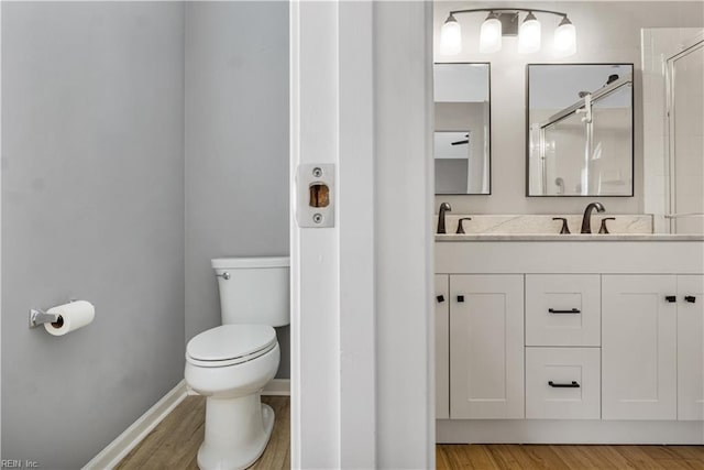 189 Shoal Crk, Williamsburg, VA 23185 - bathroom with toilet, a shower stall, double vanity, and wood finished floors