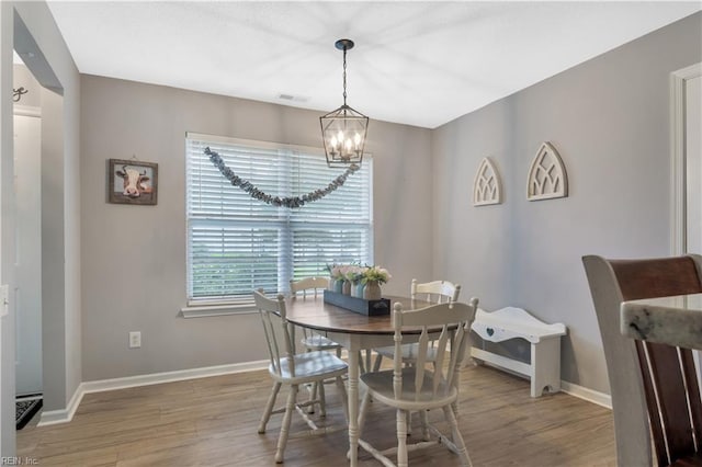 189 Shoal Crk, Williamsburg, VA 23185 - dining space with a chandelier, wood finished floors, and baseboards