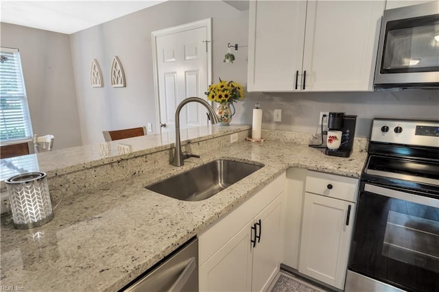 189 Shoal Crk, Williamsburg, VA 23185 - kitchen with stainless steel appliances, a sink, white cabinetry, and light stone counters