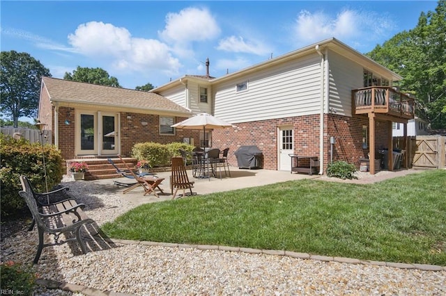 1 Hatteras Lndg, Hampton, VA 23669 - rear view of house featuring brick siding, a gate, a patio area, and a balcony