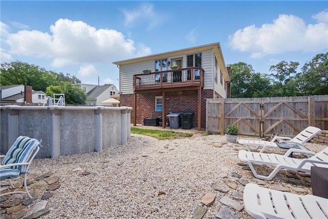 1 Hatteras Lndg, Hampton, VA 23669 - back of house with a deck and brick siding