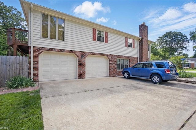 1 Hatteras Lndg, Hampton, VA 23669 - view of front facade with brick siding, a garage, a chimney, and concrete driveway