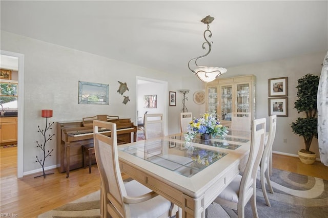 1 Hatteras Lndg, Hampton, VA 23669 - dining space featuring light wood-style flooring, baseboards, and a chandelier