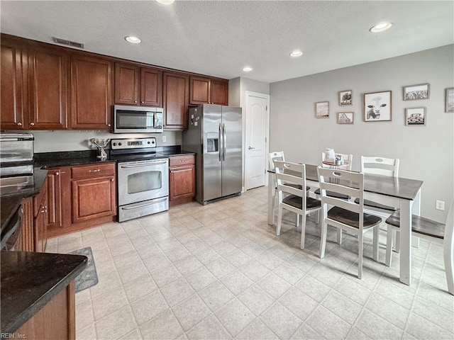 5541 Frog Pond Ln, Virginia Beach, VA 23455 - kitchen with stainless steel appliances, dark countertops, recessed lighting, and a textured ceiling