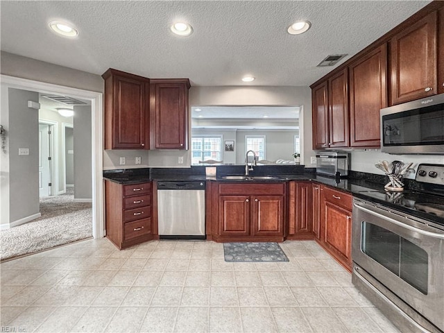 5541 Frog Pond Ln, Virginia Beach, VA 23455 - kitchen with stainless steel appliances, a sink, a textured ceiling, recessed lighting, and baseboards