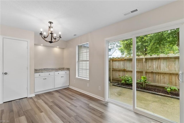 5352 Bardith Cir, Virginia Beach, VA 23455 - unfurnished dining area featuring light wood finished floors, a chandelier, and baseboards