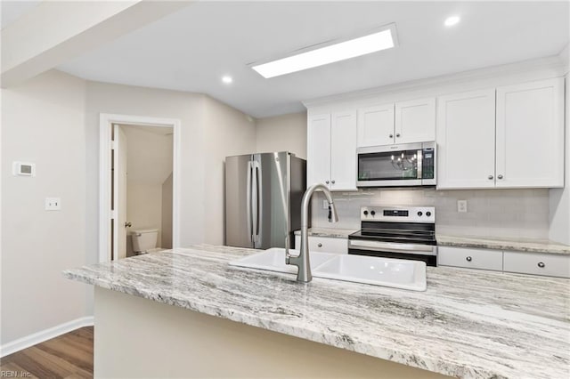 5352 Bardith Cir, Virginia Beach, VA 23455 - kitchen featuring appliances with stainless steel finishes, backsplash, white cabinets, baseboards, and dark wood finished floors