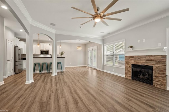 1120 Veranda Way, Chesapeake, VA 23320 - unfurnished living room with ceiling fan, a fireplace, crown molding, light wood-type flooring, and baseboards