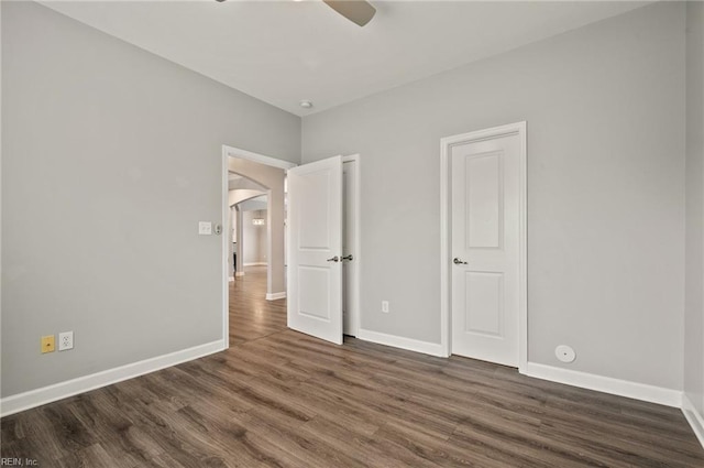 1120 Veranda Way, Chesapeake, VA 23320 - unfurnished bedroom with dark wood-style flooring, baseboards, arched walkways, and a ceiling fan