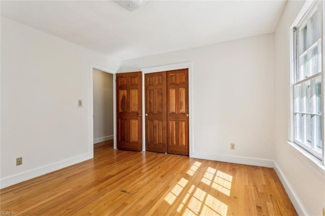 829 Prince Phillip Dr, Virginia Beach, VA 23452 - unfurnished bedroom featuring light wood finished floors, multiple windows, and baseboards