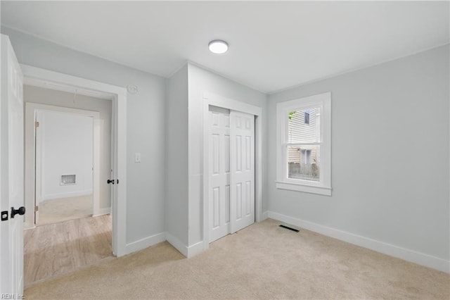 111 S Lloyd St, Suffolk, VA 23434 - unfurnished bedroom featuring carpet, a closet, and baseboards