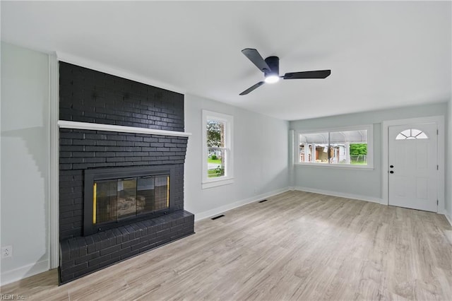 111 S Lloyd St, Suffolk, VA 23434 - unfurnished living room with wood finished floors, ceiling fan, a brick fireplace, and baseboards