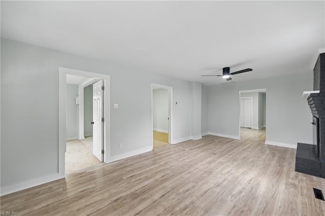 111 S Lloyd St, Suffolk, VA 23434 - unfurnished living room with light wood-style floors, ceiling fan, a fireplace, and baseboards