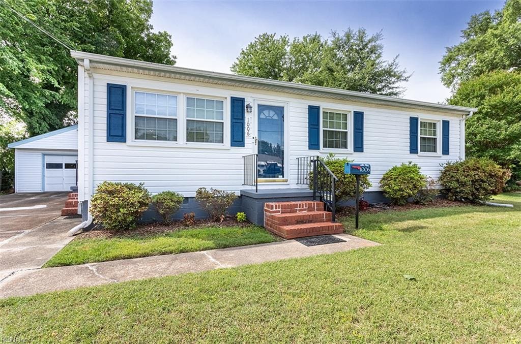 1006 76th St, Newport News, VA 23605 - view of front of property with an outdoor structure, a front yard, a garage, and crawl space