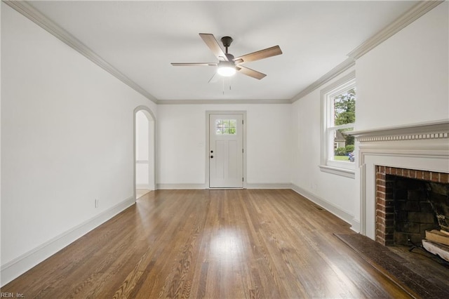 8715 Semmes Ave, Norfolk, VA 23503 - unfurnished living room featuring wood finished floors, healthy amount of natural light, a ceiling fan, ornamental molding, and a brick fireplace