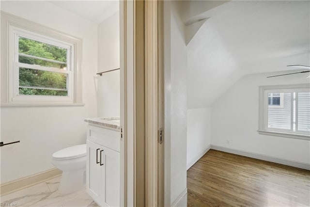 8715 Semmes Ave, Norfolk, VA 23503 - bathroom featuring vanity, toilet, vaulted ceiling, ceiling fan, and baseboards