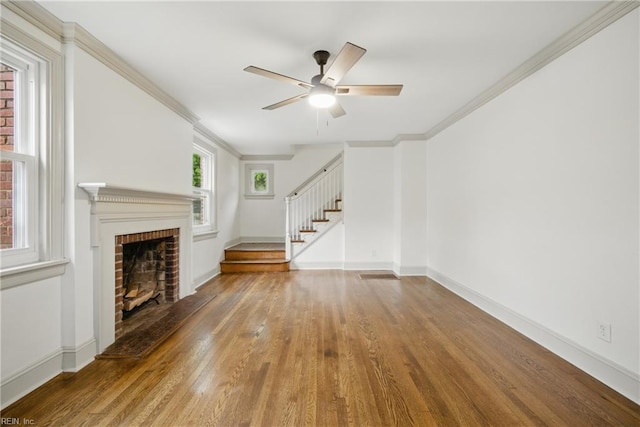8715 Semmes Ave, Norfolk, VA 23503 - unfurnished living room featuring ceiling fan, stairway, wood finished floors, a brick fireplace, and baseboards