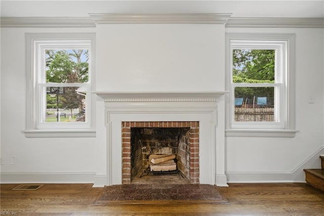 8715 Semmes Ave, Norfolk, VA 23503 - detailed view of wood finished floors, baseboards, ornamental molding, and a brick fireplace