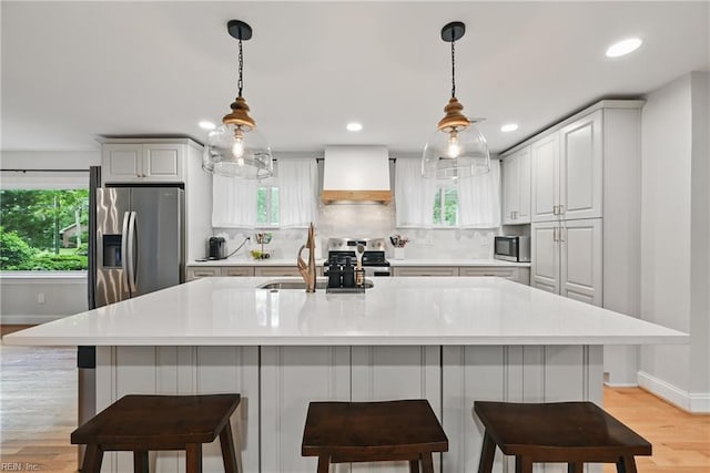 4629 Hermitage Rd, Virginia Beach, VA 23455 - kitchen with custom exhaust hood, appliances with stainless steel finishes, baseboards, light wood-style flooring, and recessed lighting