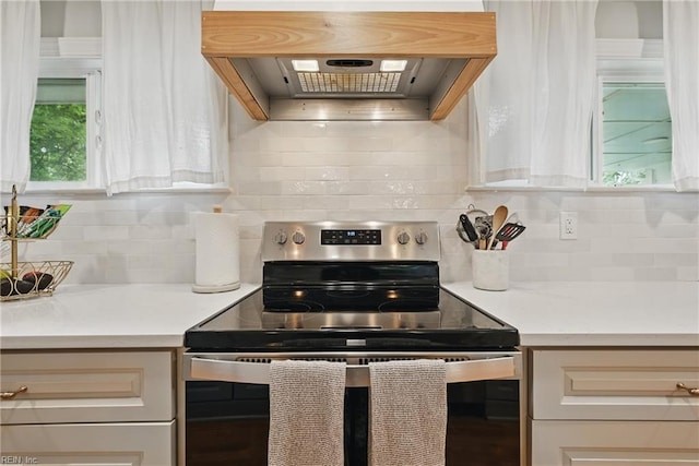 4629 Hermitage Rd, Virginia Beach, VA 23455 - kitchen with stainless steel range with electric cooktop, ventilation hood, decorative backsplash, and light countertops