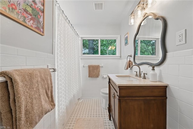 4629 Hermitage Rd, Virginia Beach, VA 23455 - full bathroom with tile walls, vanity, toilet, and wainscoting