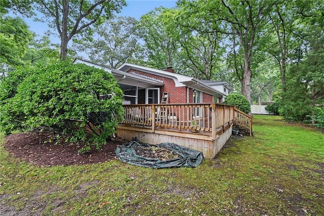 4629 Hermitage Rd, Virginia Beach, VA 23455 - rear view of house with a deck, a lawn, a chimney, brick siding, and a sunroom