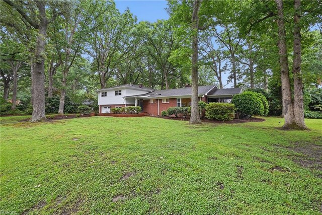 4629 Hermitage Rd, Virginia Beach, VA 23455 - view of front of property featuring a front yard, an attached garage, and brick siding
