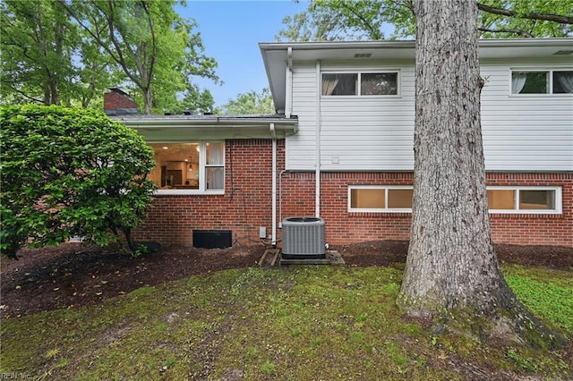 4629 Hermitage Rd, Virginia Beach, VA 23455 - rear view of house featuring cooling unit, brick siding, and a chimney