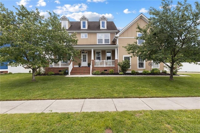1025 Sullivan Ln, Chesapeake, VA 23322 - view of front of home featuring covered porch, a front yard, board and batten siding, and crawl space