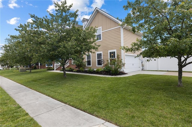 1025 Sullivan Ln, Chesapeake, VA 23322 - view of front of home featuring board and batten siding, a front yard, concrete driveway, and a garage