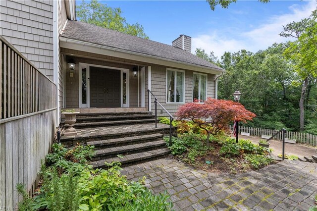 400 Discovery Rd, Virginia Beach, VA 23451 - entrance to property with a chimney, a shingled roof, and a patio