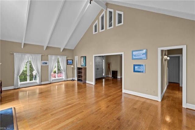 400 Discovery Rd, Virginia Beach, VA 23451 - unfurnished living room with high vaulted ceiling, baseboards, beam ceiling, wood finished floors, and a chandelier