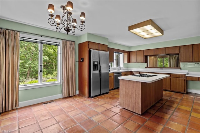 400 Discovery Rd, Virginia Beach, VA 23451 - kitchen with appliances with stainless steel finishes, light countertops, a chandelier, baseboards, and plenty of natural light