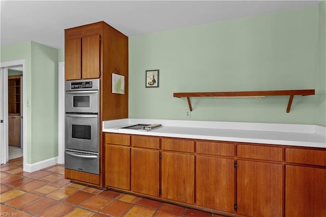 400 Discovery Rd, Virginia Beach, VA 23451 - kitchen with a warming drawer, light countertops, double oven, and brown cabinetry