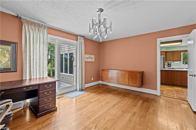 400 Discovery Rd, Virginia Beach, VA 23451 - unfurnished office featuring light wood finished floors, a textured ceiling, a chandelier, and baseboards