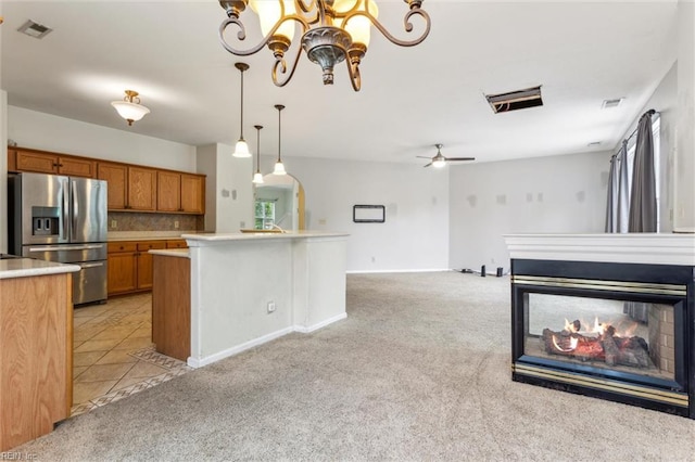 109 Lenora Cv, Smithfield, VA 23430 - kitchen featuring stainless steel refrigerator with ice dispenser, brown cabinets, light colored carpet, and light countertops