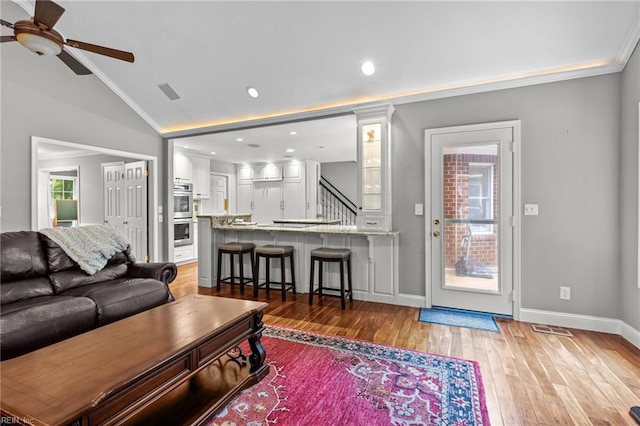 3121 Audley Way, Virginia Beach, VA 23452 - living area with ceiling fan, vaulted ceiling, light wood-style floors, stairway, and baseboards