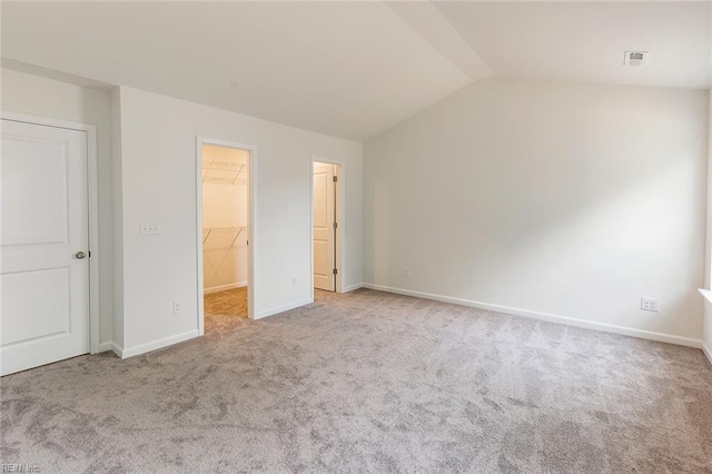 4408 Abercorn Dr, Suffolk, VA 23435 - unfurnished bedroom featuring a spacious closet, carpet floors, lofted ceiling, and baseboards